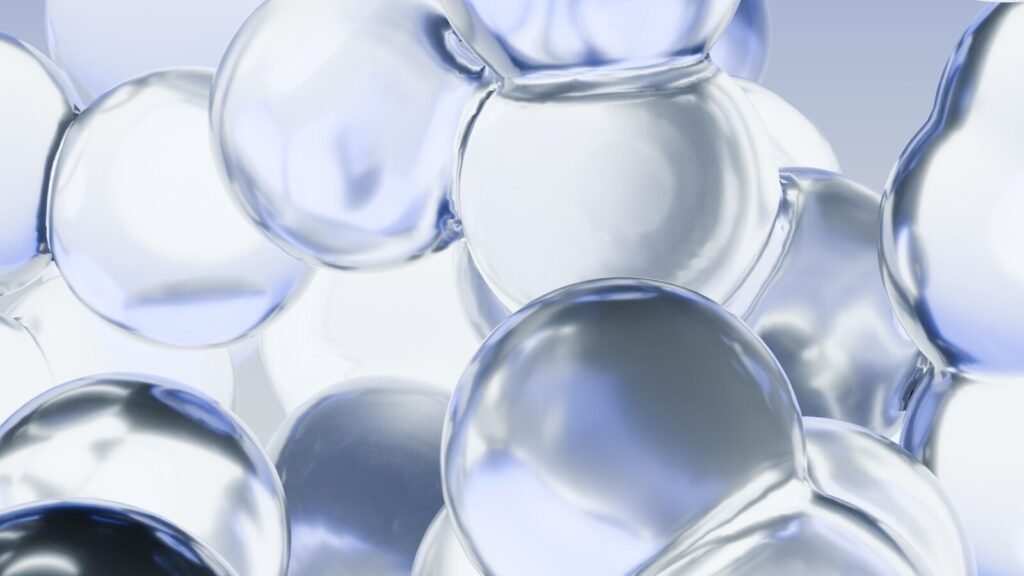 Numerous clear, reflective spheres with blue and white highlights.